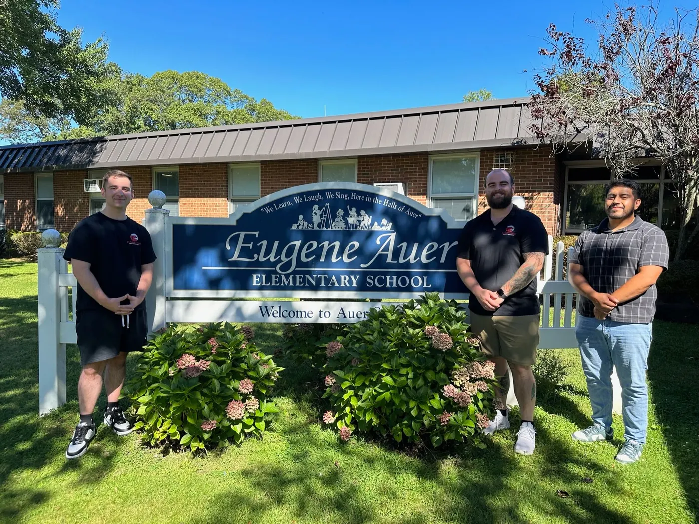 Team members outside Eugene Auer Elementary School